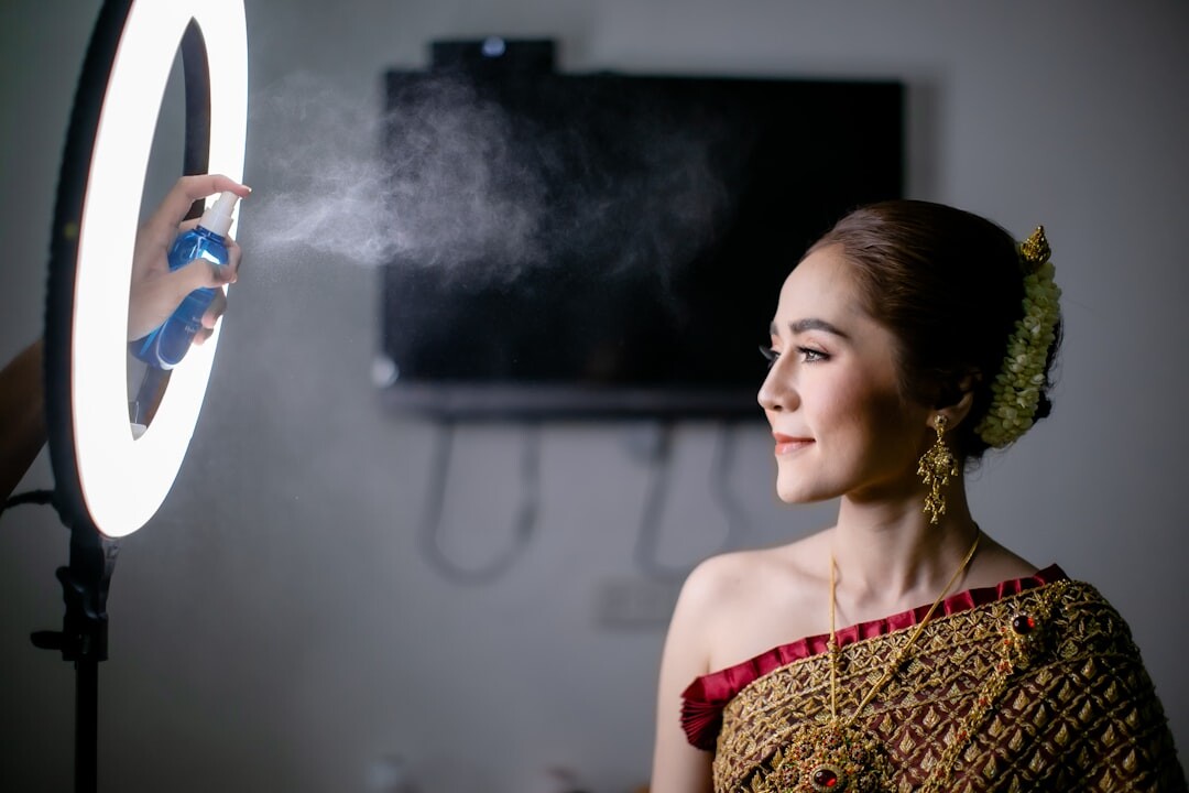 Young influencer recording content with a smartphone and ring light
