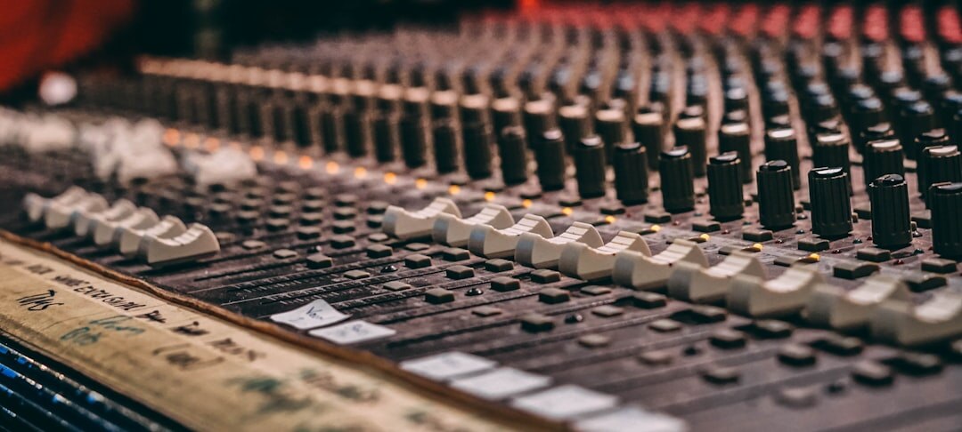 Close-up of a microphone and mixing equipment in a recording studio